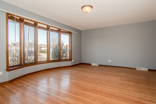 spare room with light hardwood / wood-style flooring