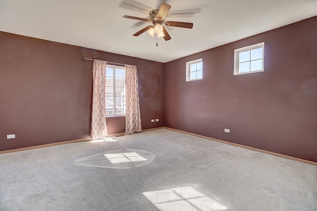 unfurnished room with light carpet, plenty of natural light, and ceiling fan