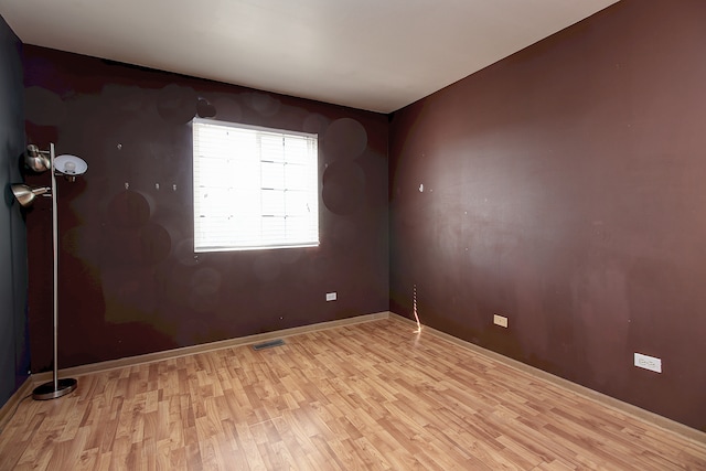 unfurnished room featuring light hardwood / wood-style floors