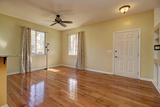 foyer with light wood-type flooring and ceiling fan