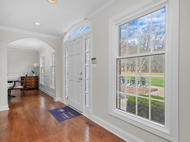 entrance foyer featuring dark hardwood / wood-style floors and crown molding