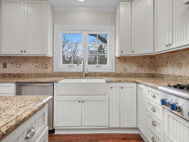 kitchen featuring sink, light stone countertops, ornamental molding, dark hardwood / wood-style flooring, and white cabinetry