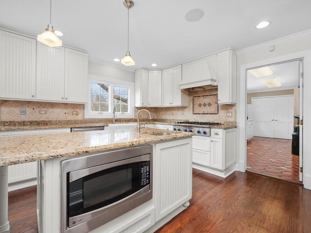 kitchen with dark hardwood / wood-style floors, white cabinetry, stainless steel appliances, and custom range hood