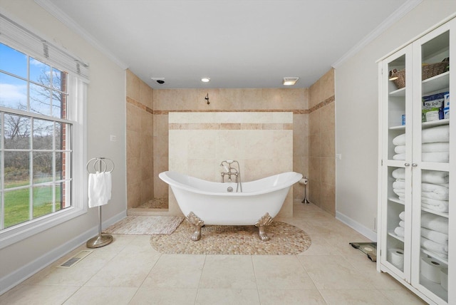 bathroom featuring a bathing tub, tile patterned flooring, crown molding, and tile walls