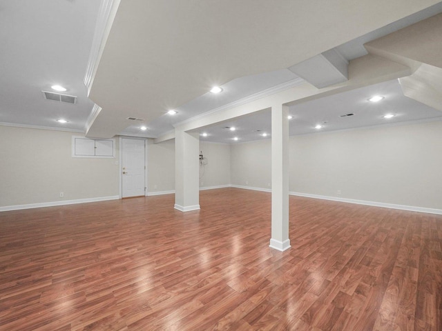 basement featuring hardwood / wood-style floors and ornamental molding