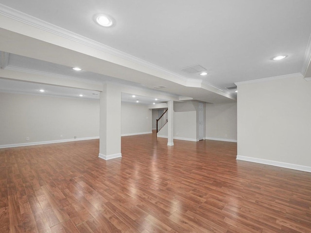 basement with hardwood / wood-style floors and ornamental molding