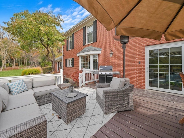 wooden deck with outdoor lounge area and grilling area