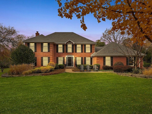 colonial inspired home with a yard