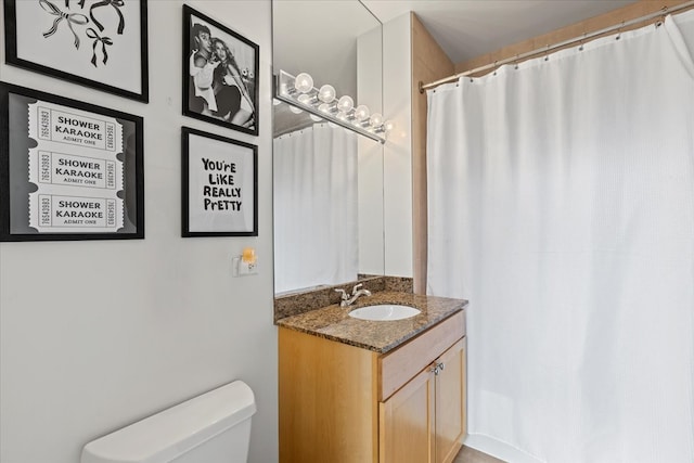 bathroom featuring toilet and vanity