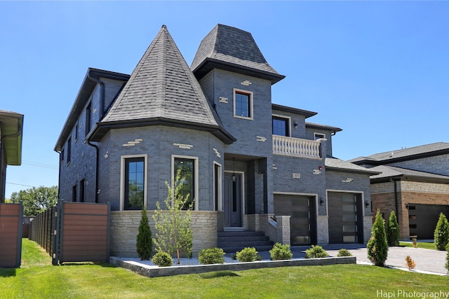 view of front facade with a front yard and a garage