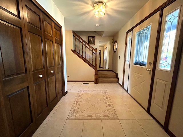 foyer entrance with light tile patterned floors