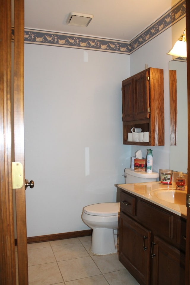 bathroom with vanity, toilet, and tile patterned floors