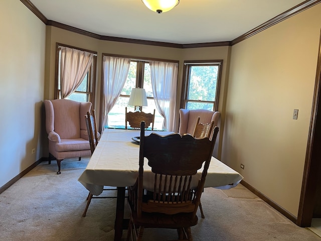 dining space featuring ornamental molding and light colored carpet