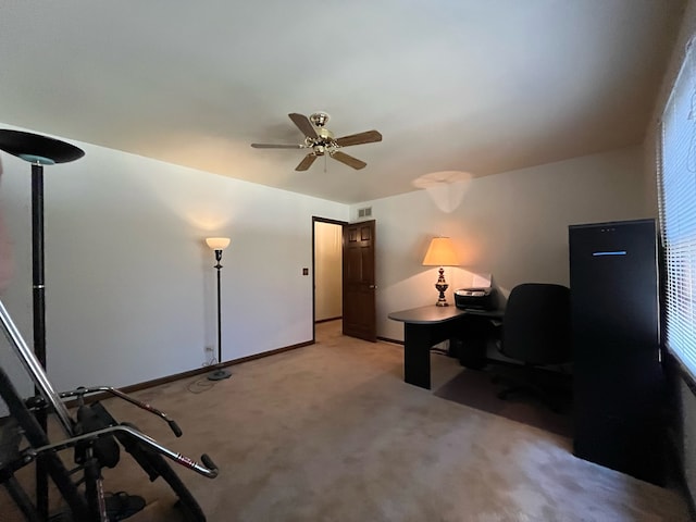 home office with light carpet, a wealth of natural light, and ceiling fan