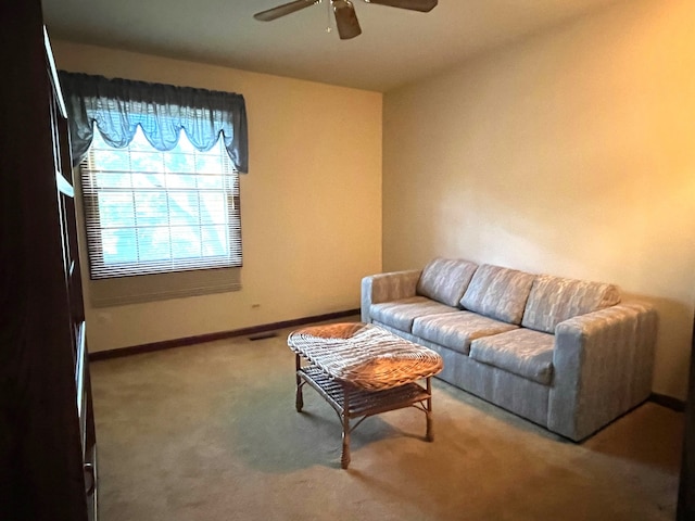 living room with ceiling fan and carpet flooring