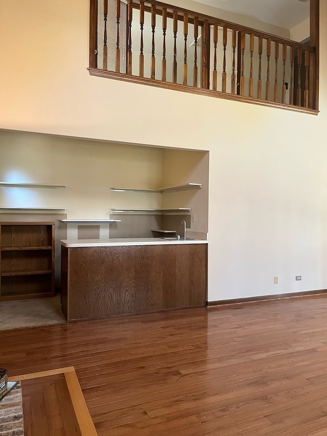 interior space with wood-type flooring and a high ceiling