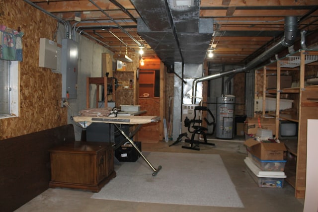 basement featuring heating unit, electric panel, and water heater