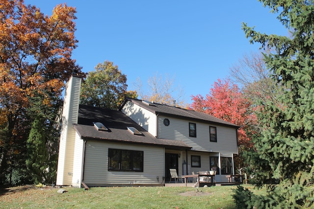 rear view of property with a yard