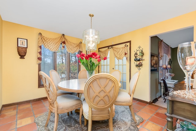 dining room featuring a notable chandelier and light tile patterned flooring