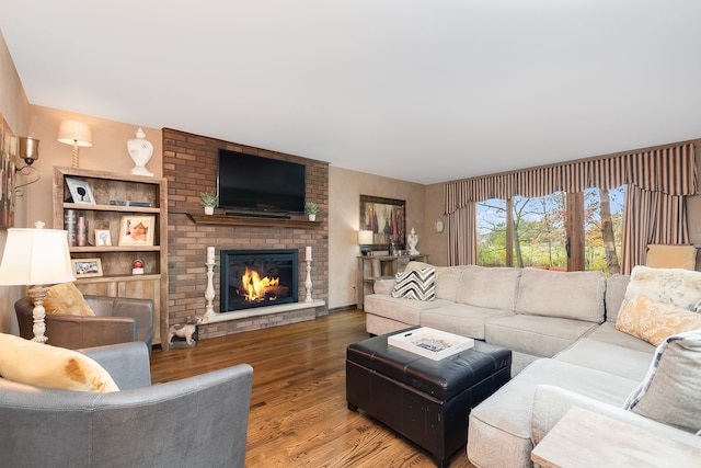 living room with wood-type flooring and a fireplace