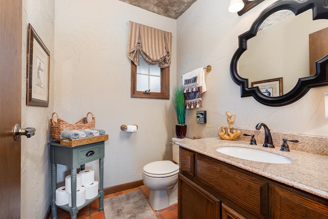 bathroom featuring toilet and vanity