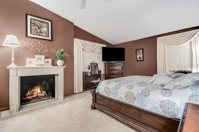 carpeted bedroom featuring vaulted ceiling and ceiling fan