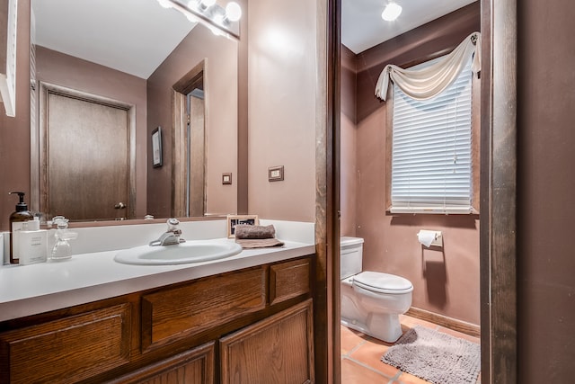 bathroom featuring vanity, toilet, and tile patterned flooring