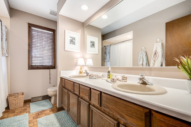 bathroom featuring vanity, toilet, and a shower with shower curtain