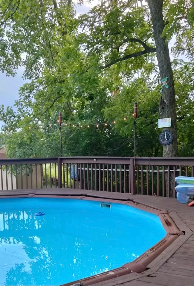 view of pool with a wooden deck