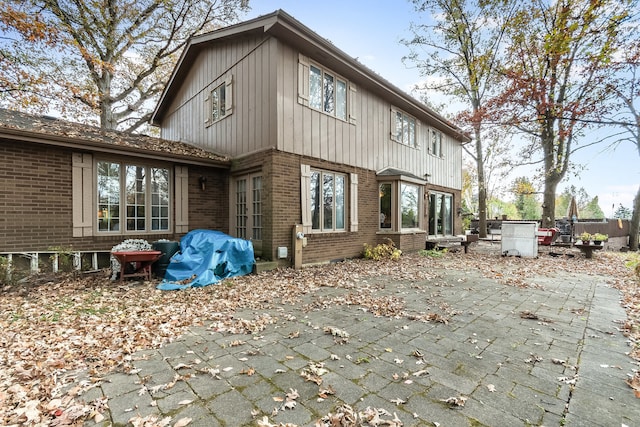 back of property with a patio