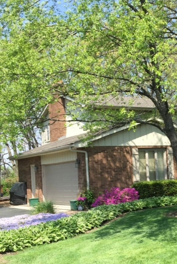 view of home's exterior with a yard and a garage