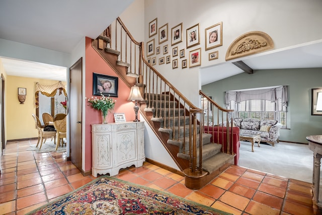 stairway featuring vaulted ceiling with beams and tile patterned flooring