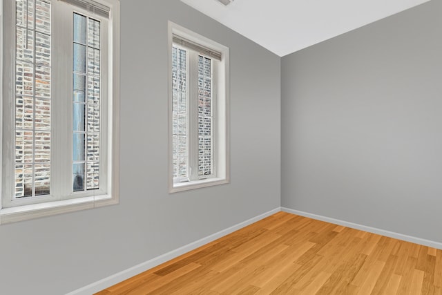 spare room featuring light hardwood / wood-style flooring and a wealth of natural light