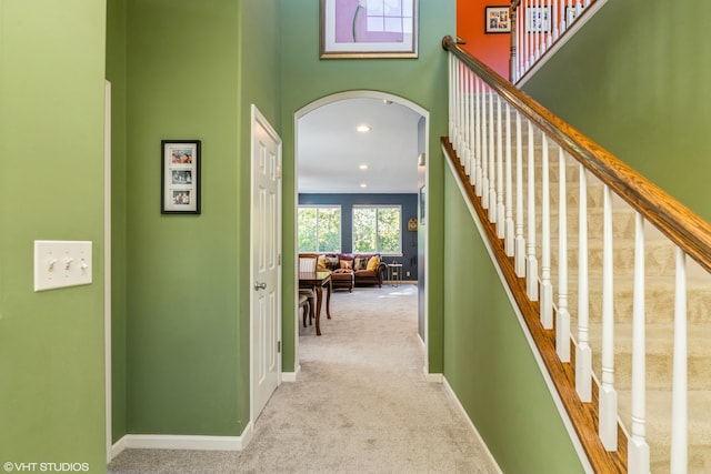 hallway with light colored carpet