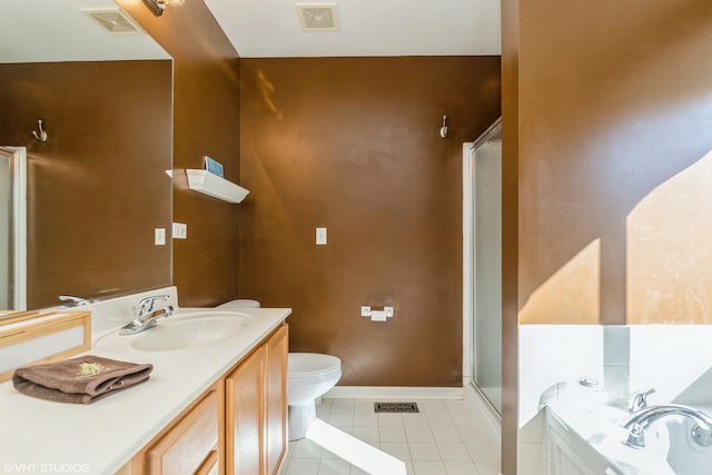 bathroom featuring vanity, a shower with shower door, toilet, and tile patterned flooring