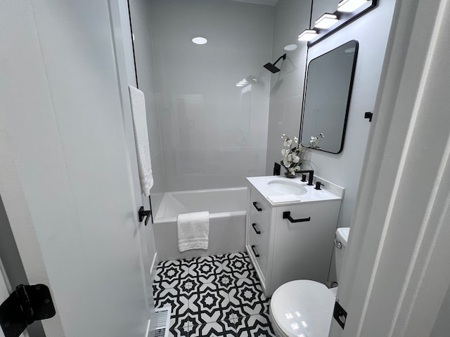 full bathroom featuring toilet, tiled shower / bath, vanity, and tile patterned flooring