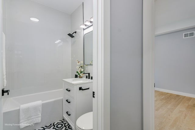 full bathroom with vanity, toilet, wood-type flooring, and shower / washtub combination