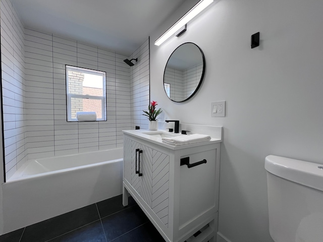 full bathroom featuring tiled shower / bath, vanity, toilet, and tile patterned floors