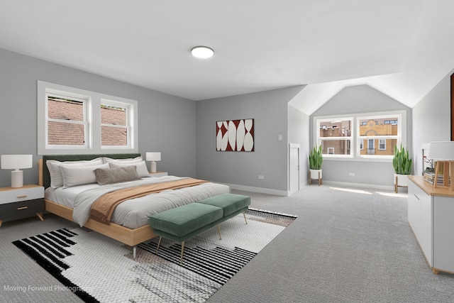 bedroom with light carpet, multiple windows, and lofted ceiling