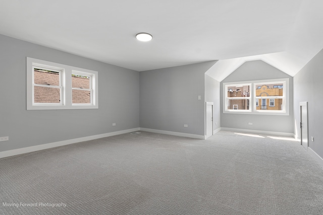 bonus room with light carpet and lofted ceiling