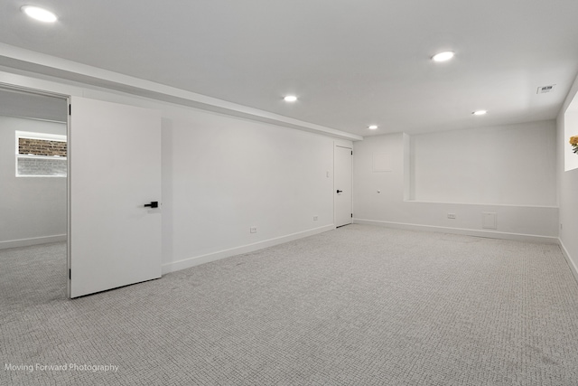 basement featuring light colored carpet