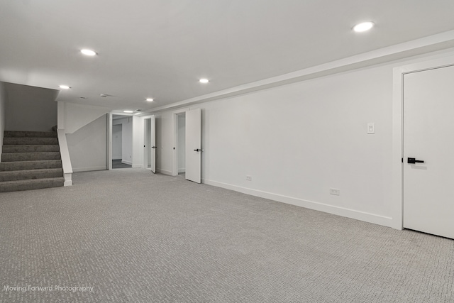 basement featuring light colored carpet