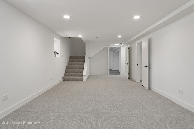 basement featuring light colored carpet