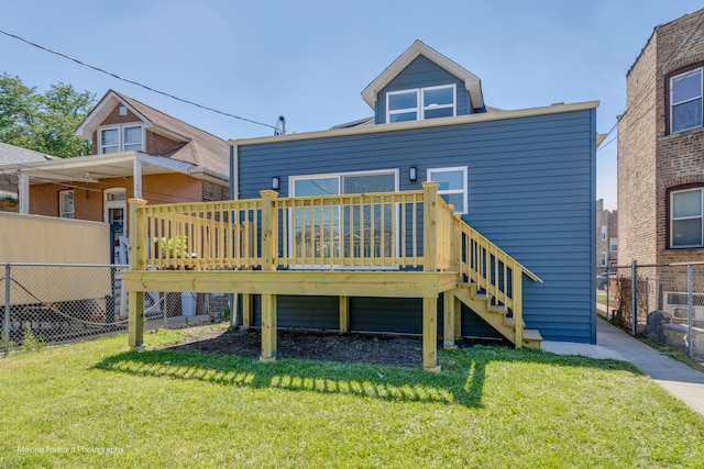 rear view of property featuring a wooden deck and a yard