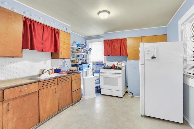 kitchen with sink, backsplash, and white appliances