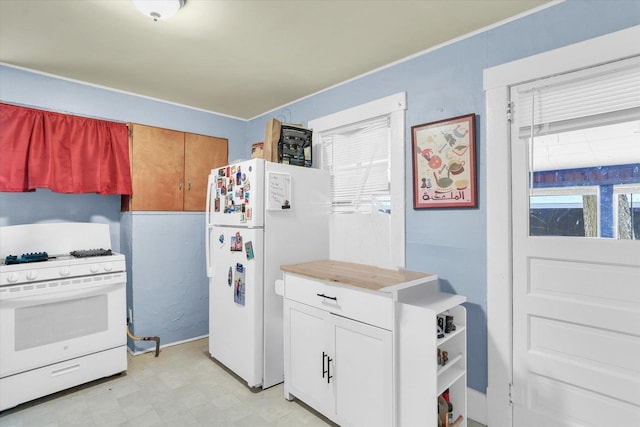 kitchen with white cabinetry and white appliances