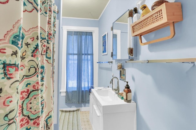 bathroom with vanity and ornamental molding