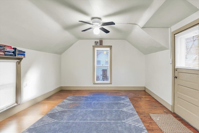 additional living space featuring lofted ceiling and dark hardwood / wood-style flooring