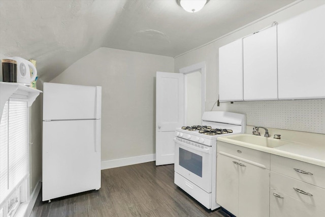 kitchen featuring white cabinetry, lofted ceiling, sink, dark hardwood / wood-style flooring, and white appliances