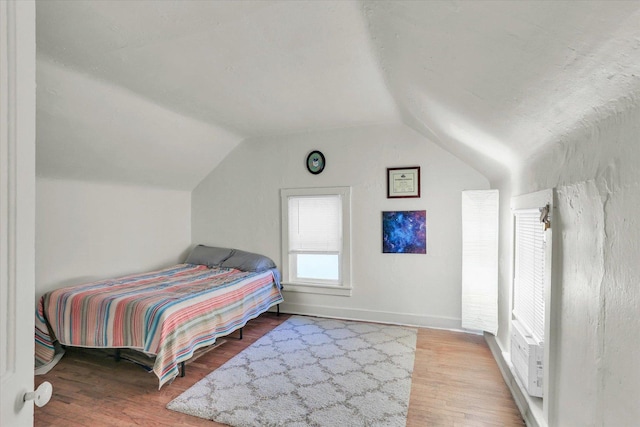 bedroom featuring vaulted ceiling and light hardwood / wood-style floors